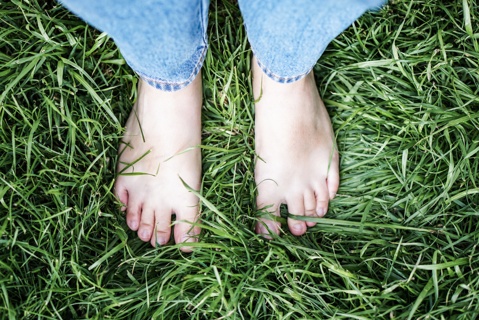 standing-grass-opt Close up of feet standing in grass